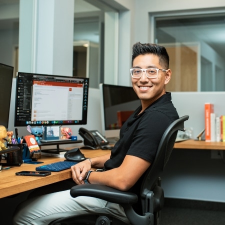 Justin Huynh sitting at his desk