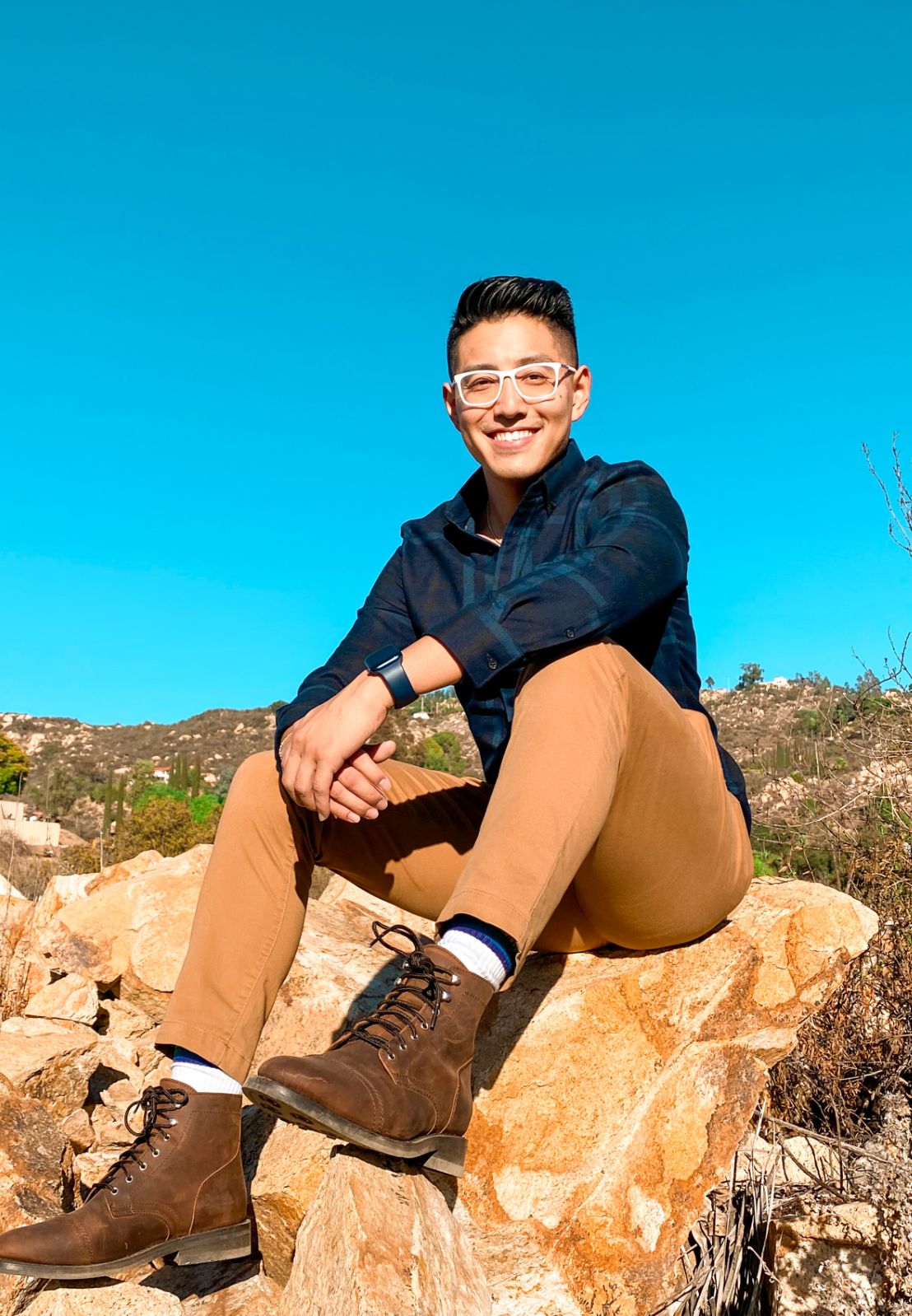 Justin Huynh sitting on a rock